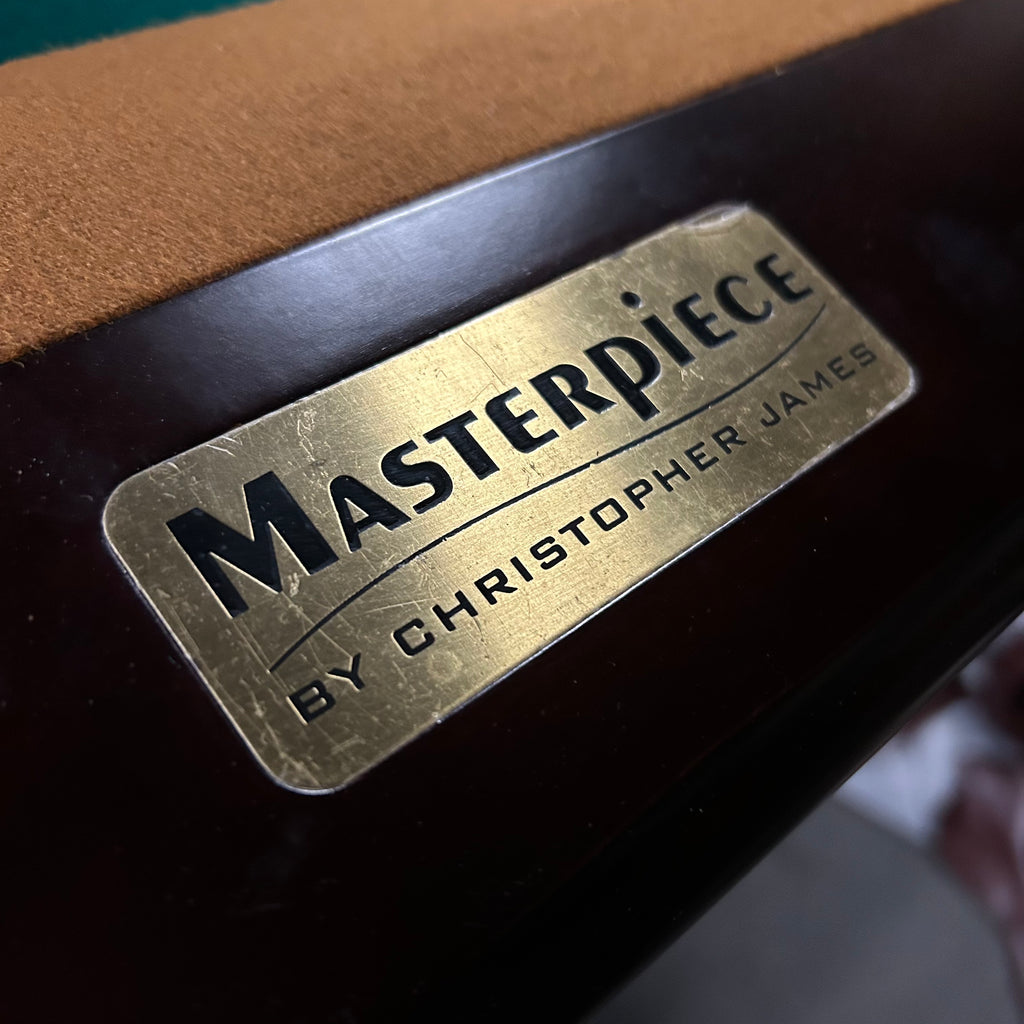 Masterpiece logo plate by christopher james on rail with brown felt\