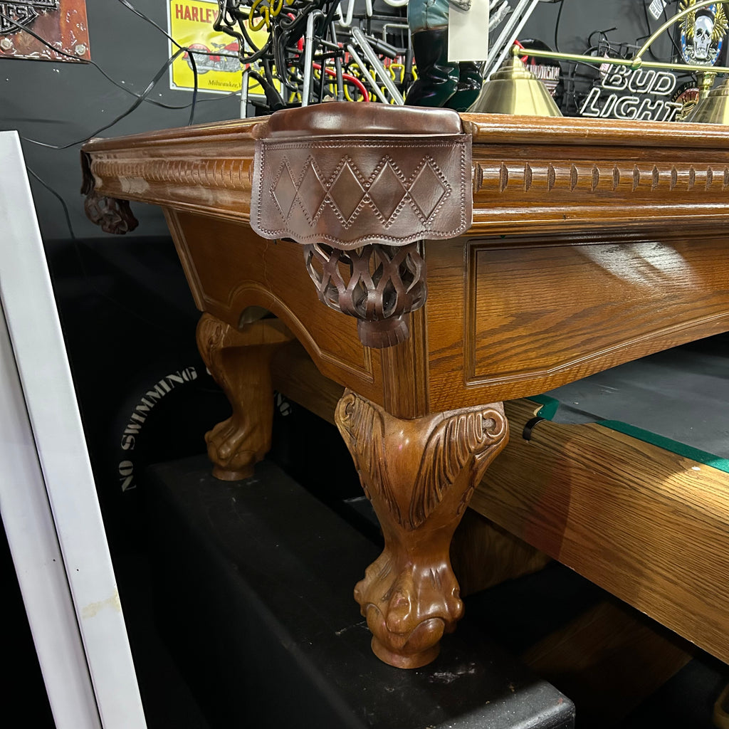 Corner view of 8ft oak pool table with ball and claw leg