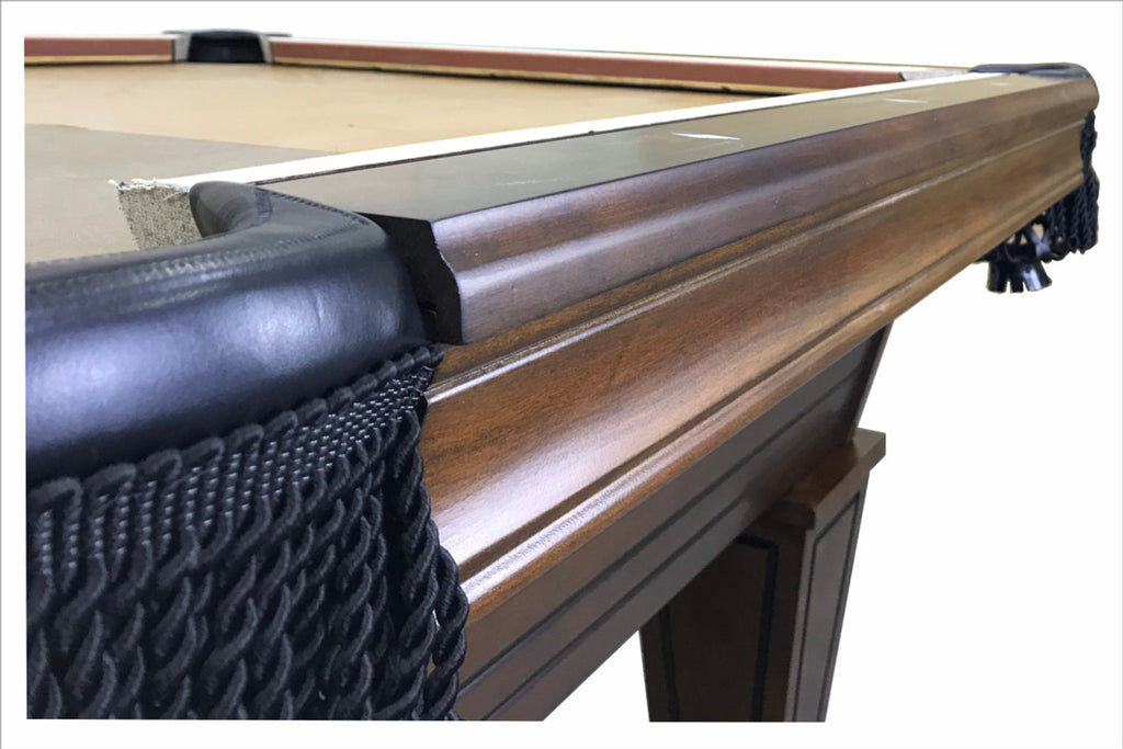 View of rails of Carrigan pool table showing black fringe pocket