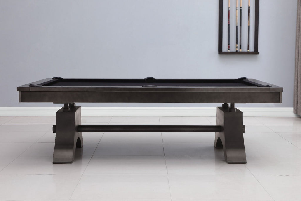 Side view of Jaxx pool table in room with wall rack on wall and black felt on table