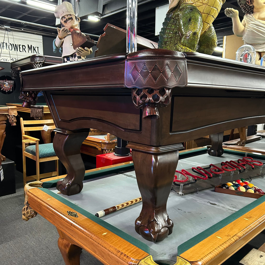 Corner view of pool table showing pocket and leg