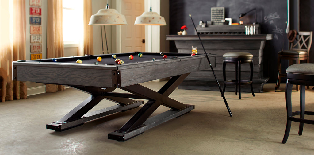 Glacier pool table with criss crossed base in glacier finish with black felt in room