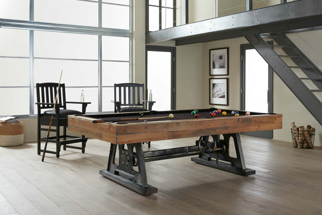 Da Vinci pool table in reclaimed wood finish with metal base and purple wine felt in room with cues and balls on table