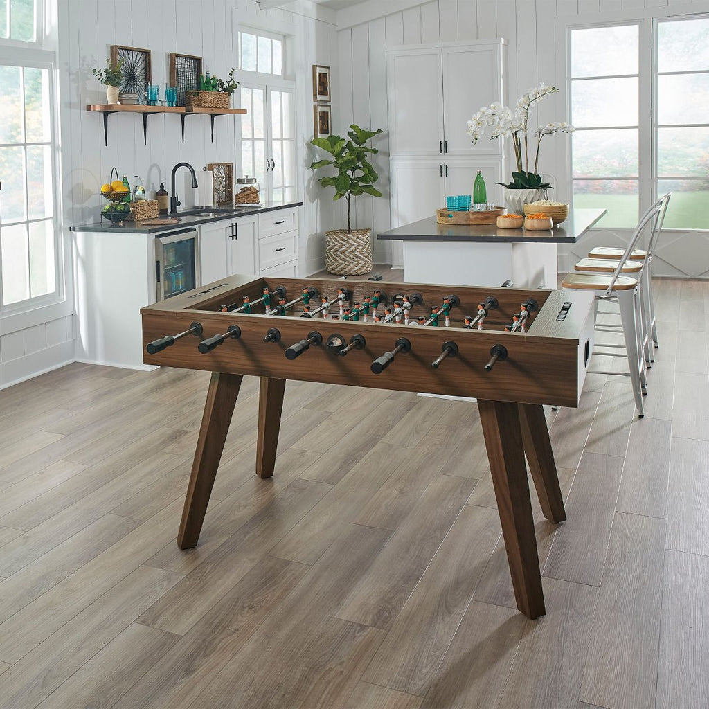 foosball table next to kitchen island in environment