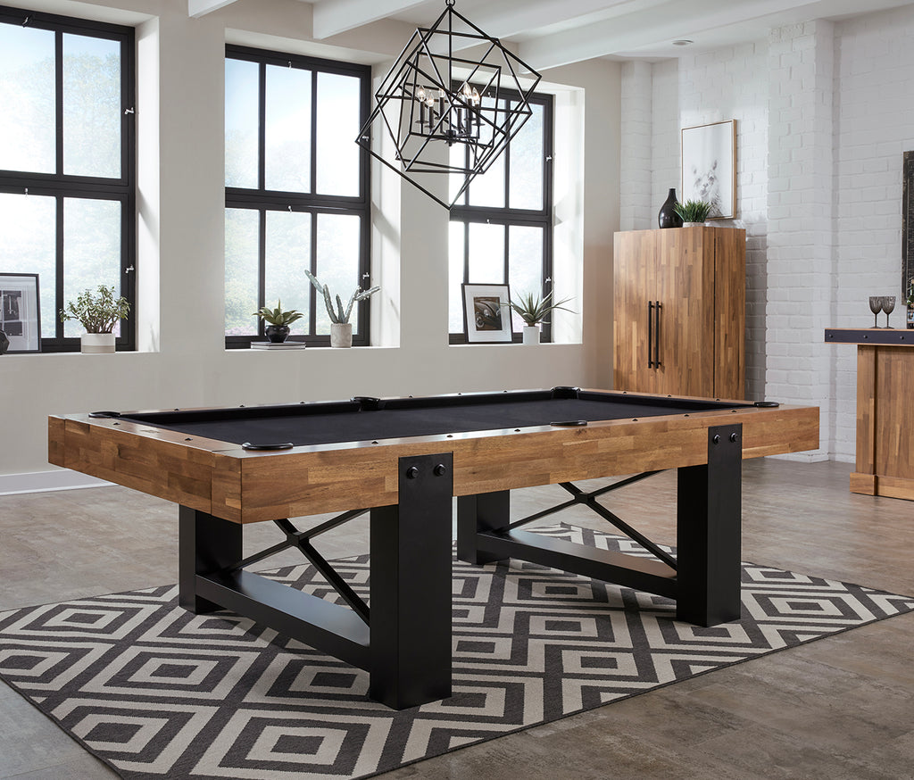 Knoxville pool table with acacia wood frame and black pedestal base accents in room with black felt