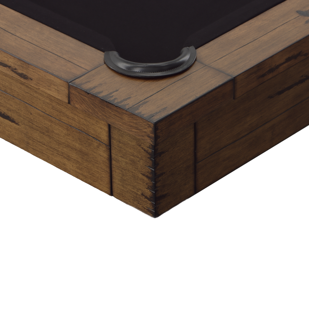 Corner of modesto pool table in whiskey finish and black leather pocket and black felt