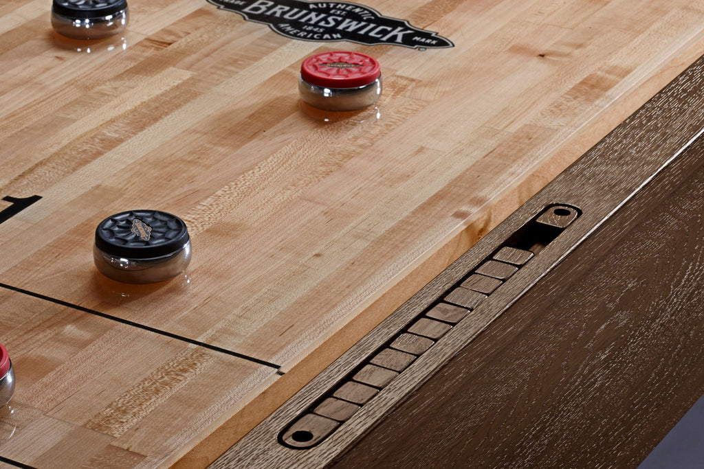 Brunswick Merrimack Shuffleboard pucks on table