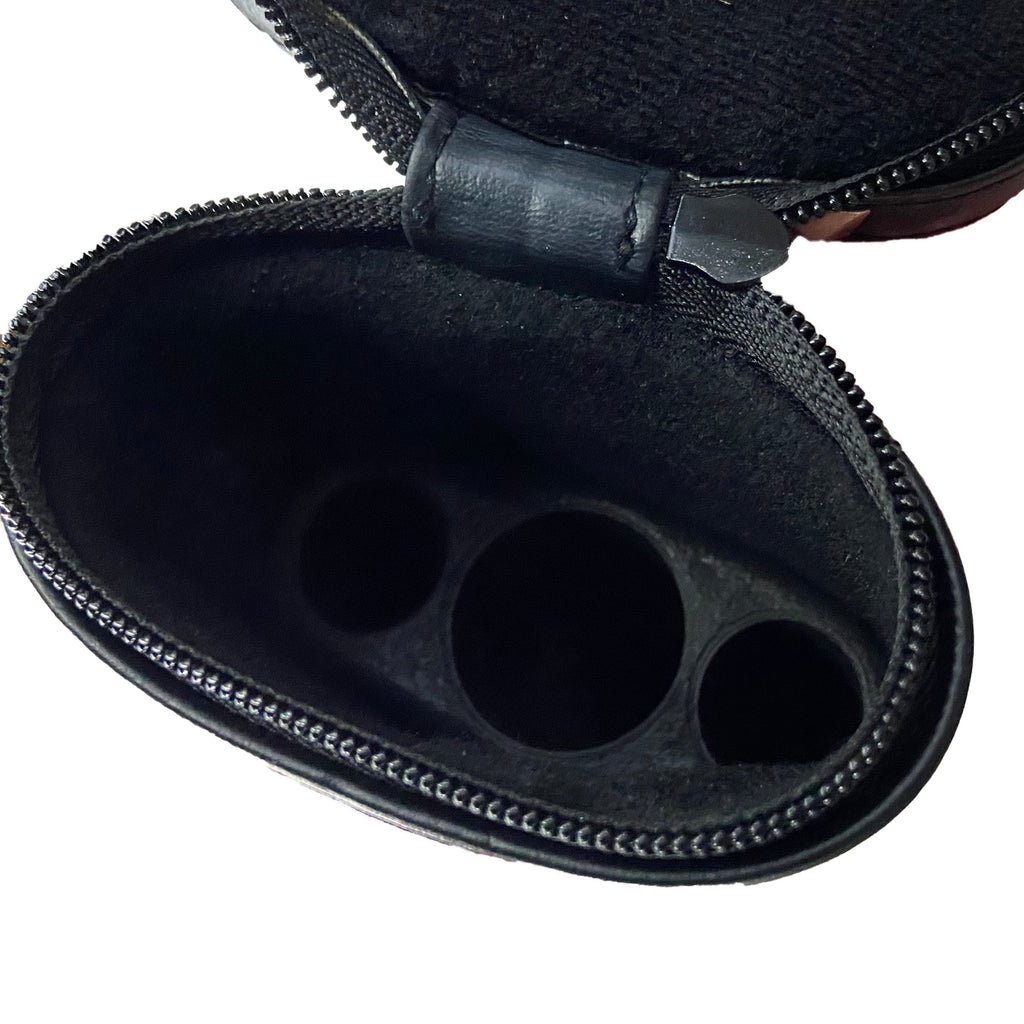 Inside of pool cue case showing holes for 2 shafts and 1 cue butt