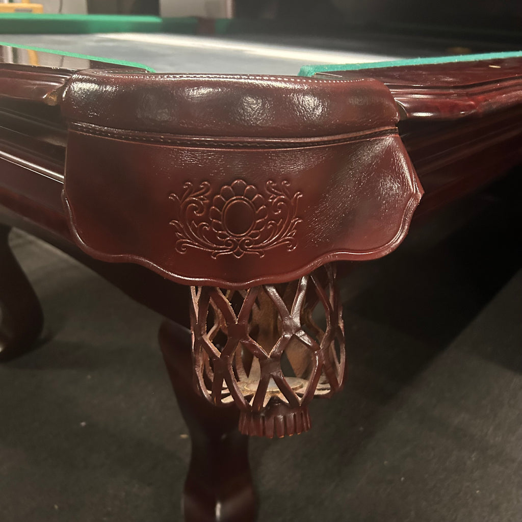 Leather pockets shield on pool table with design on front of leather 