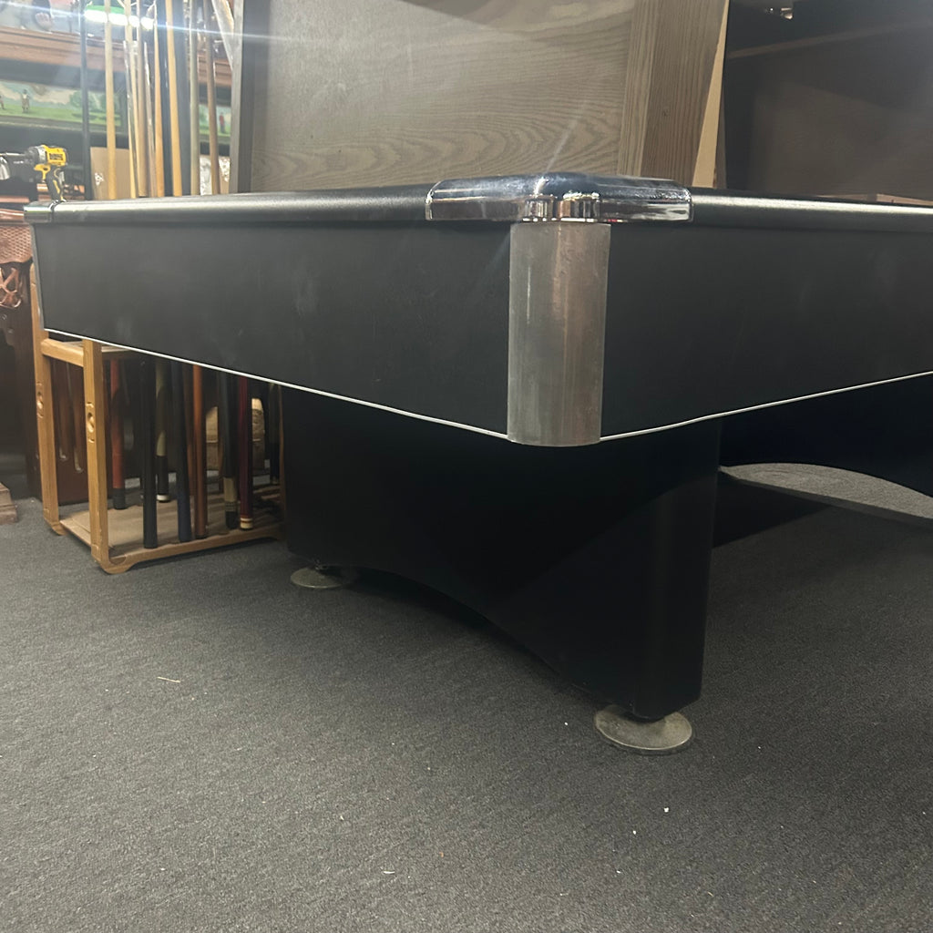 Chrome corner castings and trim on a black pool table with pedestal base leg