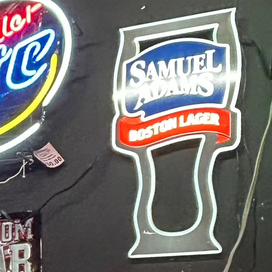 sam adams bottle outline with boston lager in red ribbon