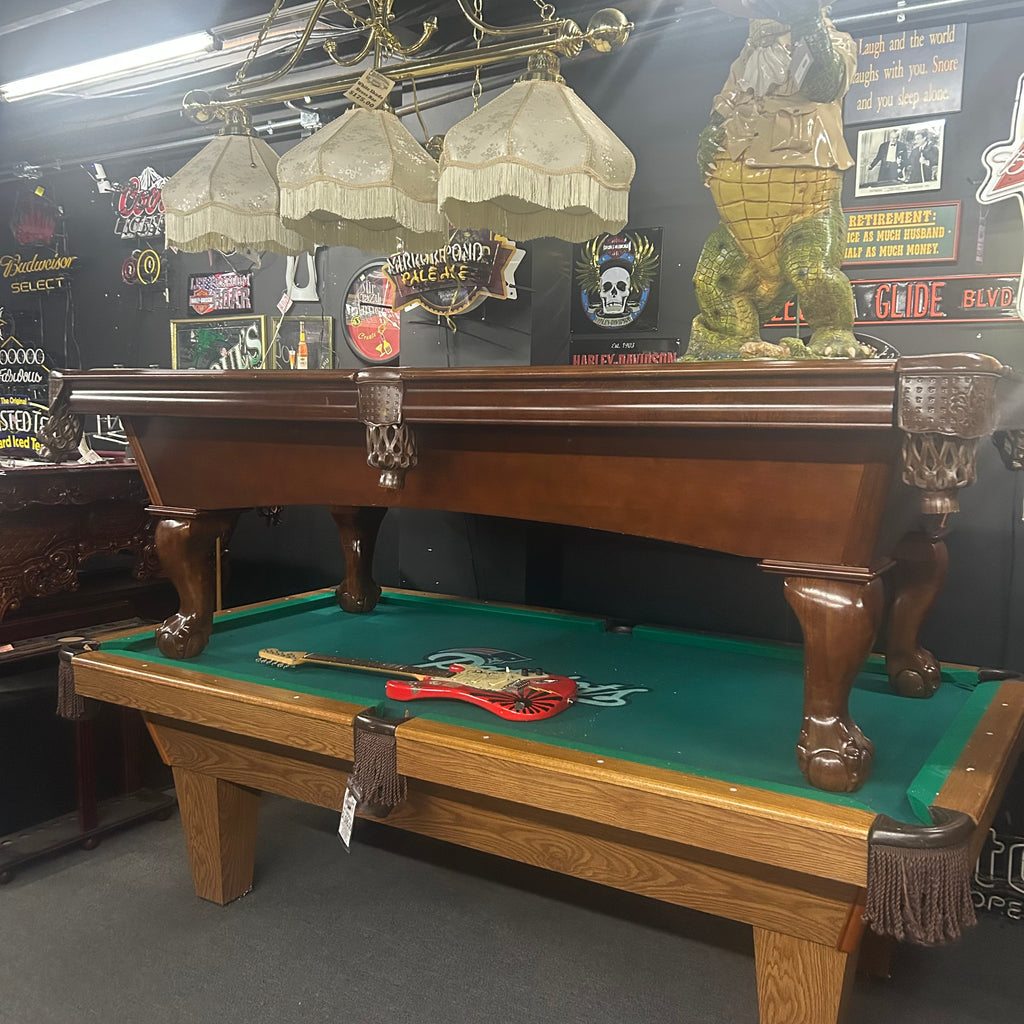 Overall view of pool table with walnut finish and leather shield pocket and ball and claw leg