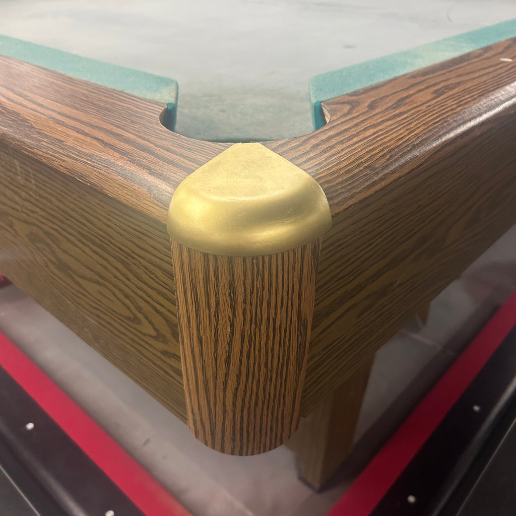 Brass corner caps on pool table with green cloth