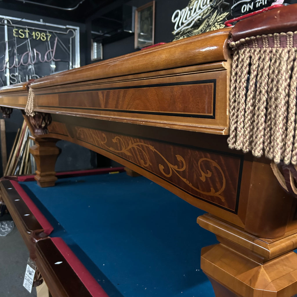 Side view of apron of pool table showing hand inlaid detail in walnut and crotch mahogany