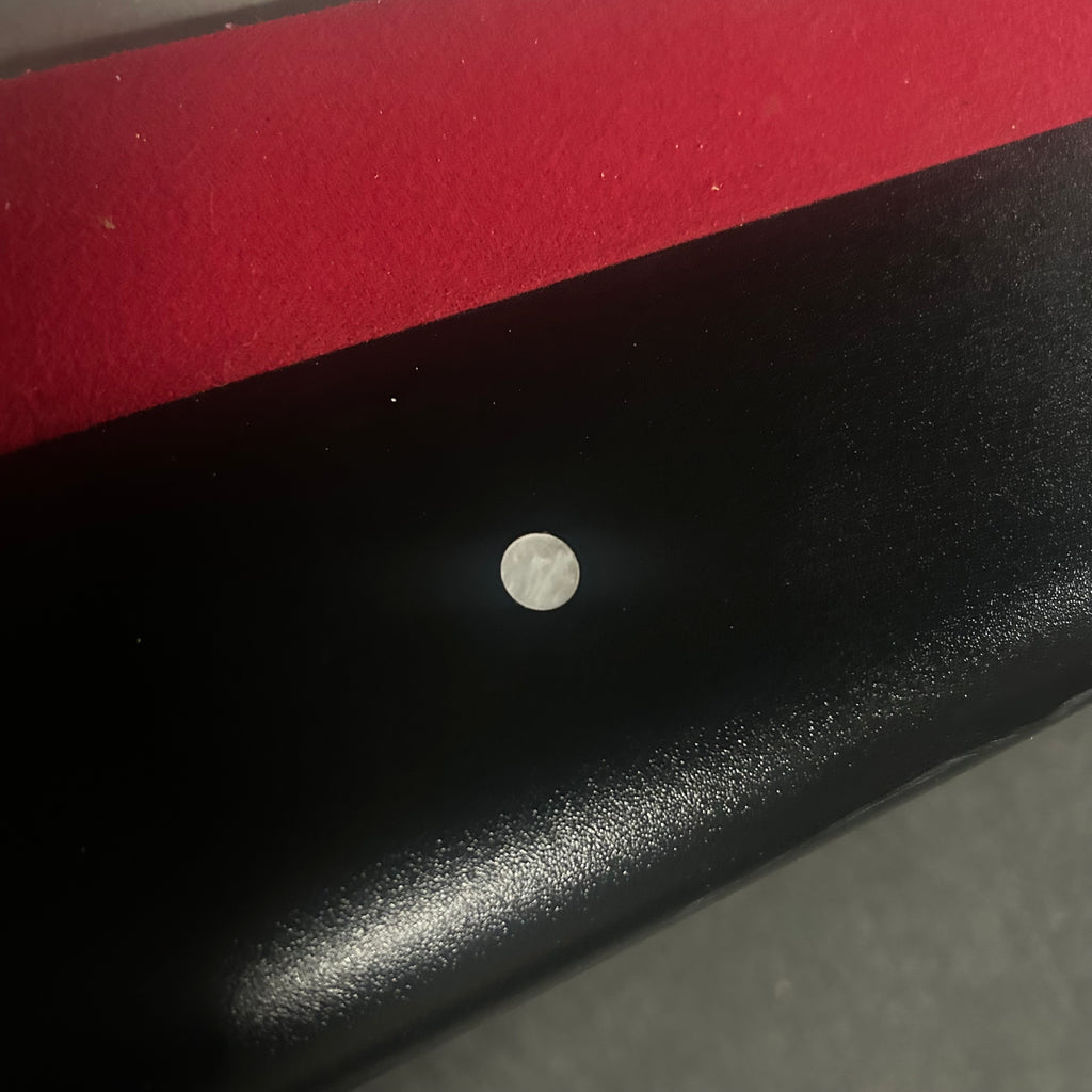Black rail and round white site with red cloth