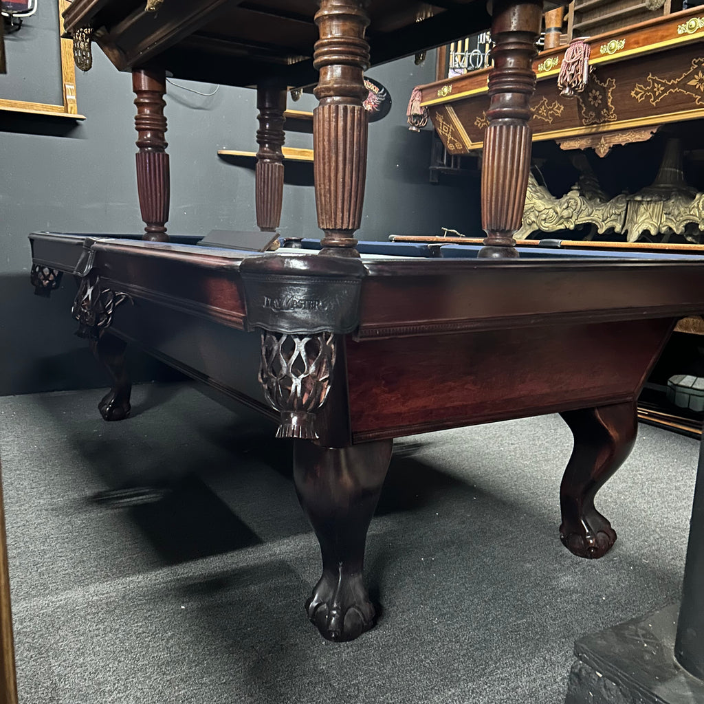Overall view of mahogany pool table with leather pocket and ball and claw legwith 