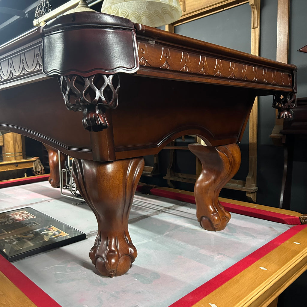 Corner view of pool table with the apron detailing and ball and claw leg
