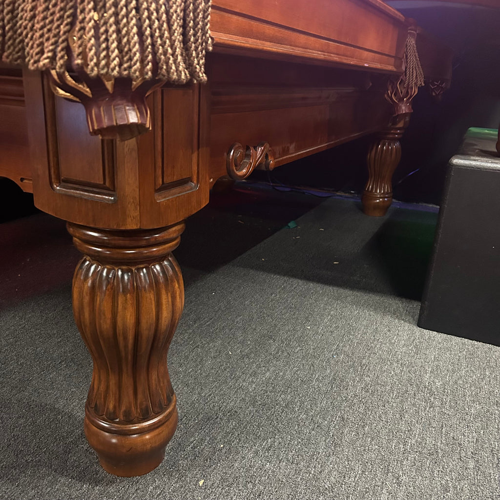 Cabinet of pool table with routed details from side
