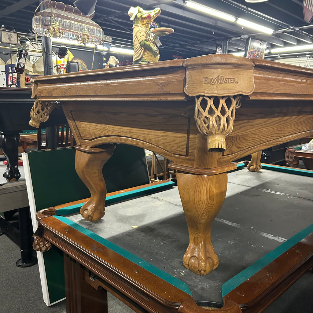 Corner view of oak finish amf pool table with ball and claw leg and shield pocket 