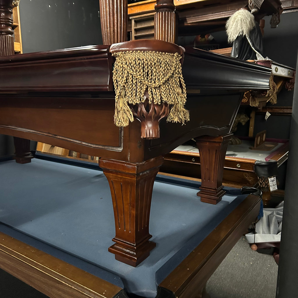 Corner view of pool table with fringe pocket and fluted leg