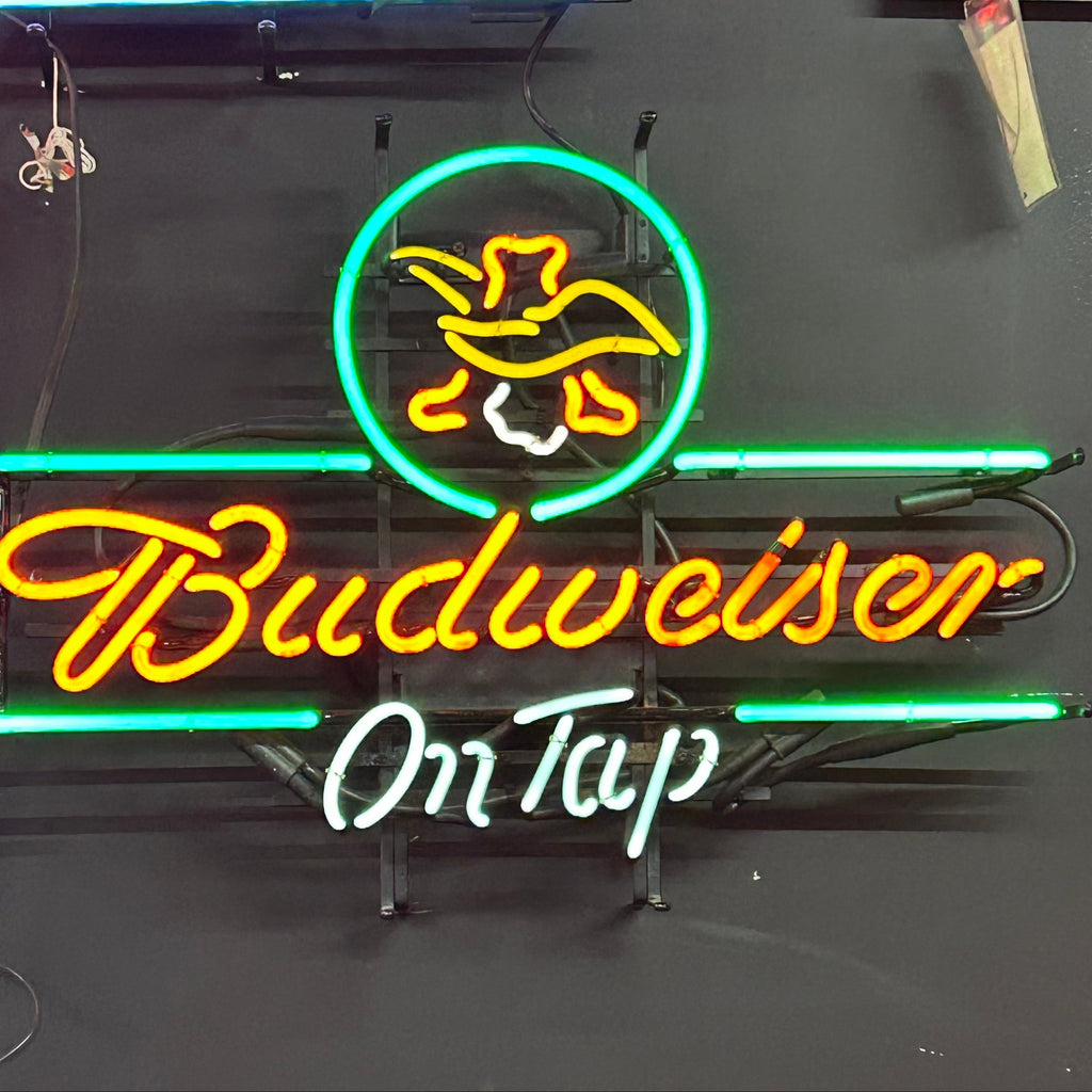 Budweiser on tap neon light in green and yellow