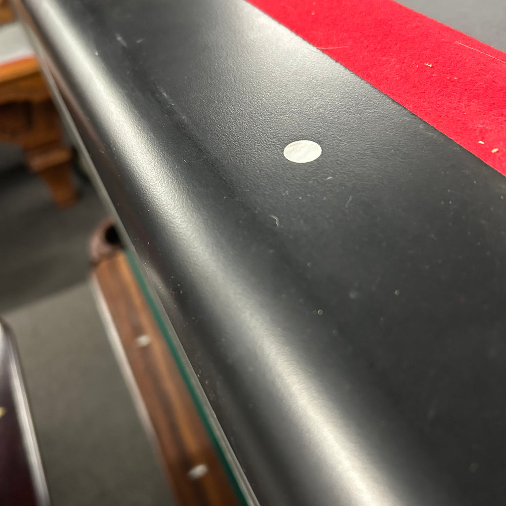 Closeup of eliminator pool table with circle sites and red cloth