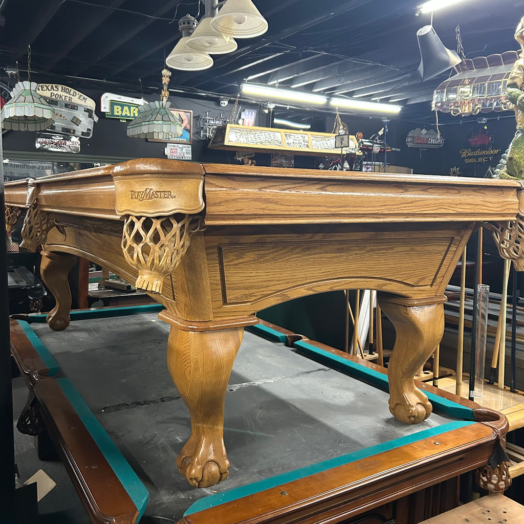 End view of oak finish amf pool table with ball and claw leg and shield pocket 