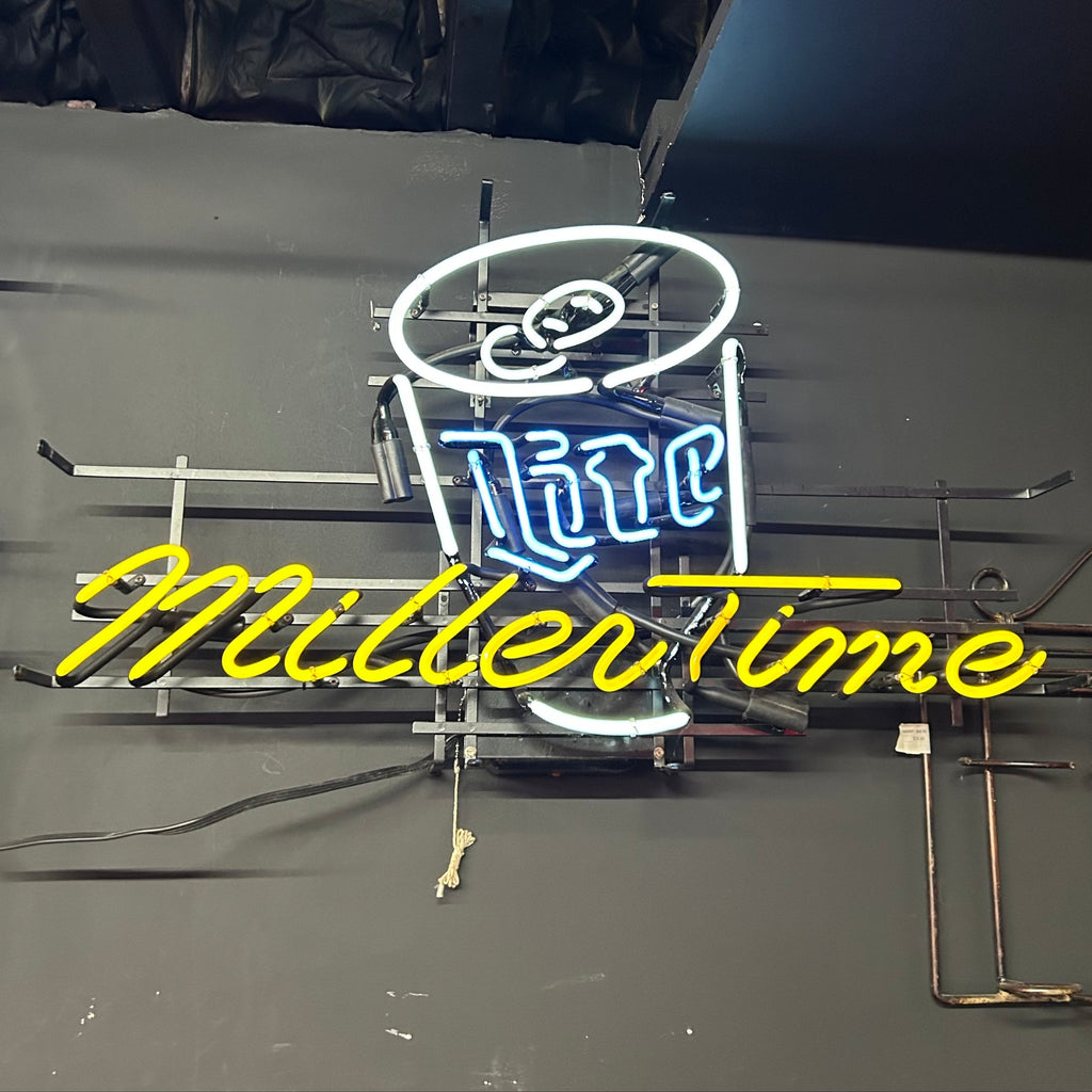 Neon Light hanging on wall with miller time in yellow, lite can in white