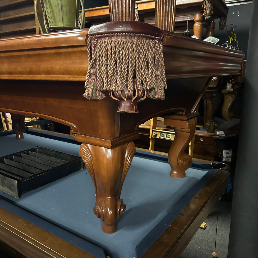 Corner view of pool table in chestnut finish with tassel fringe pocket