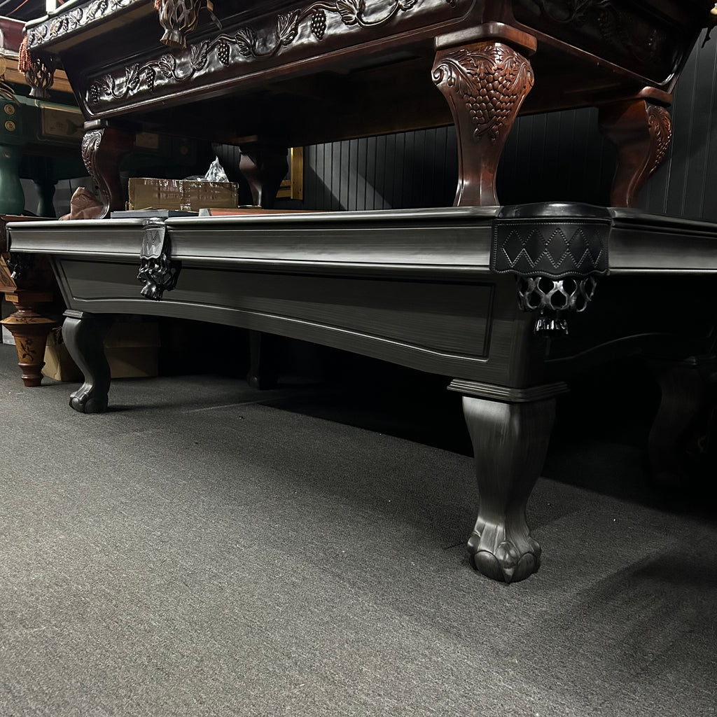 Overall floor view of kona finish pool table with black shield pocket and ball and claw leg