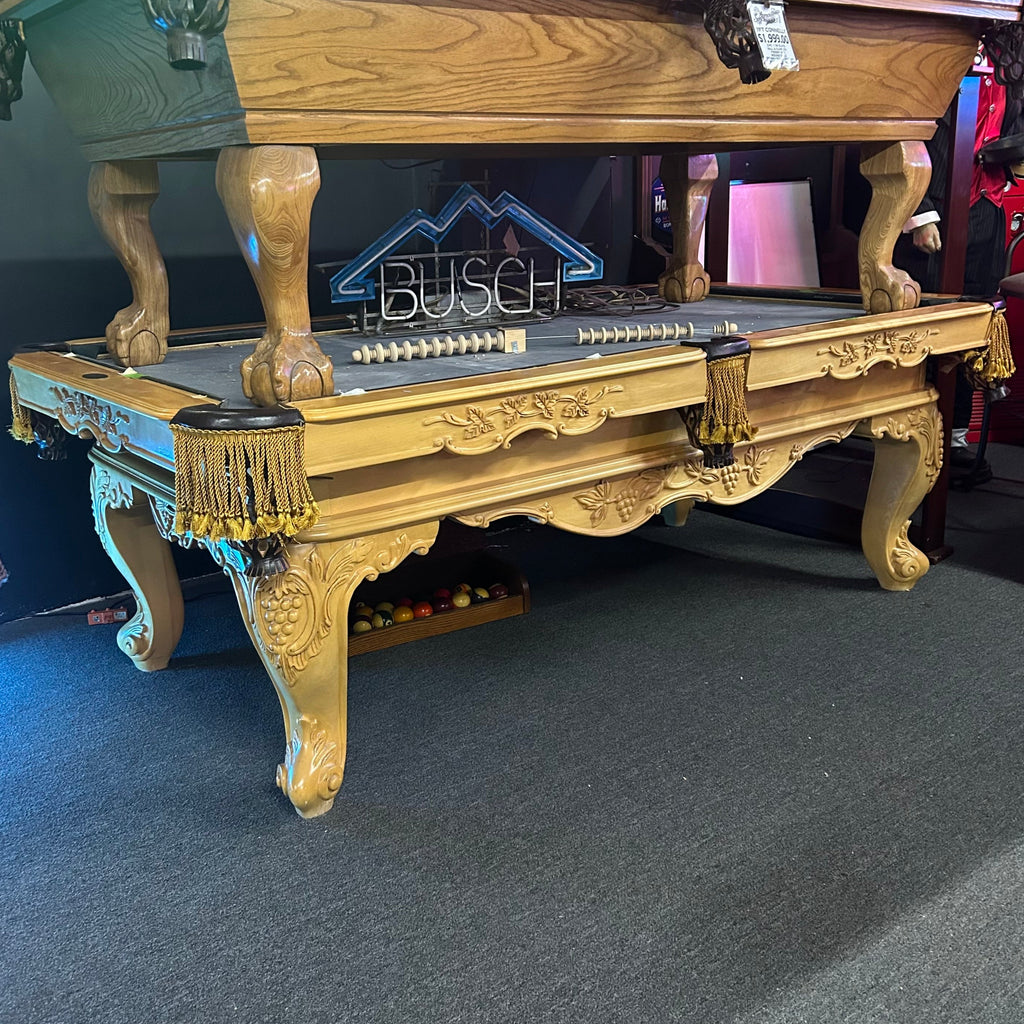 View from left side of olhausen pool table with natural finish and gold fringe pockets
