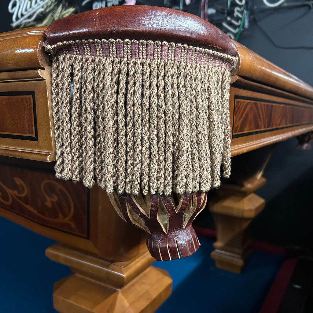 Closeup of fringe pocket on pool table with camel color