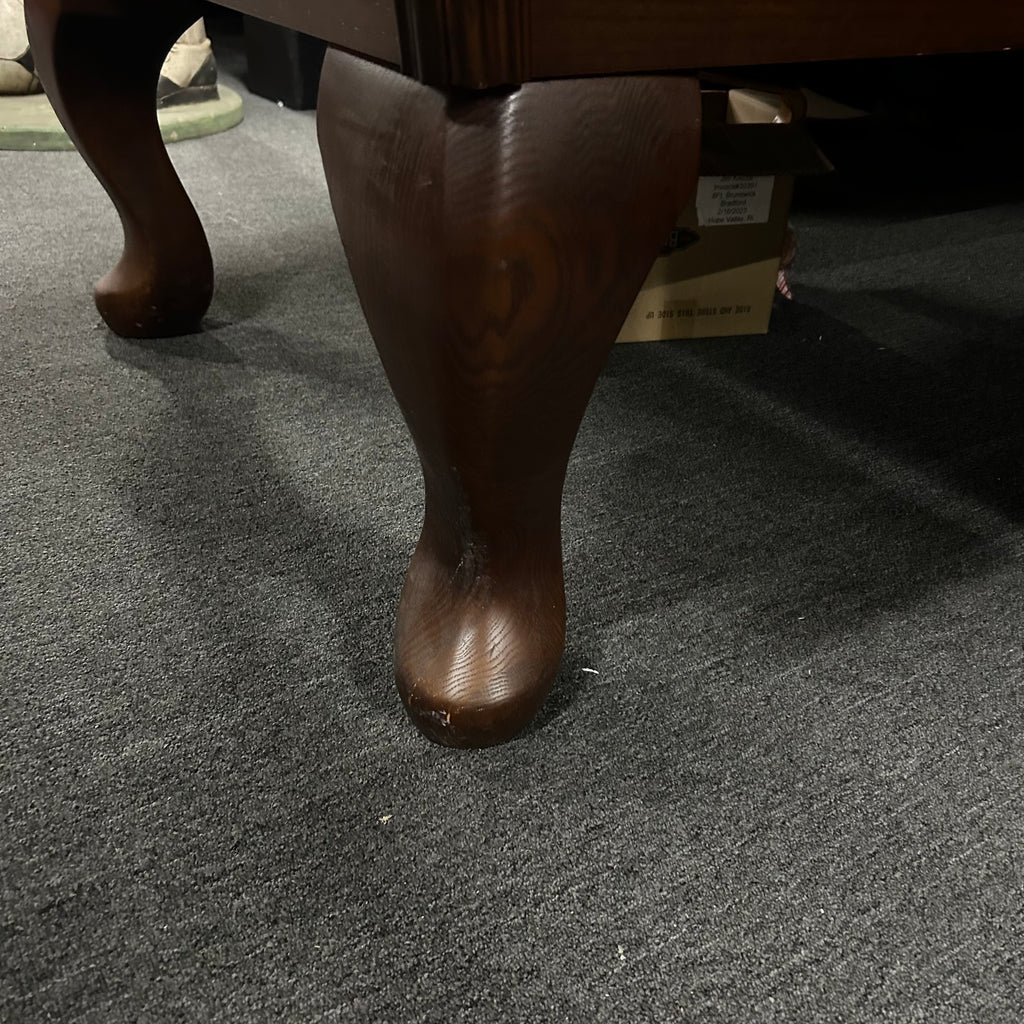 Closeup of queen ann leg on pool table in dark brown oak finish