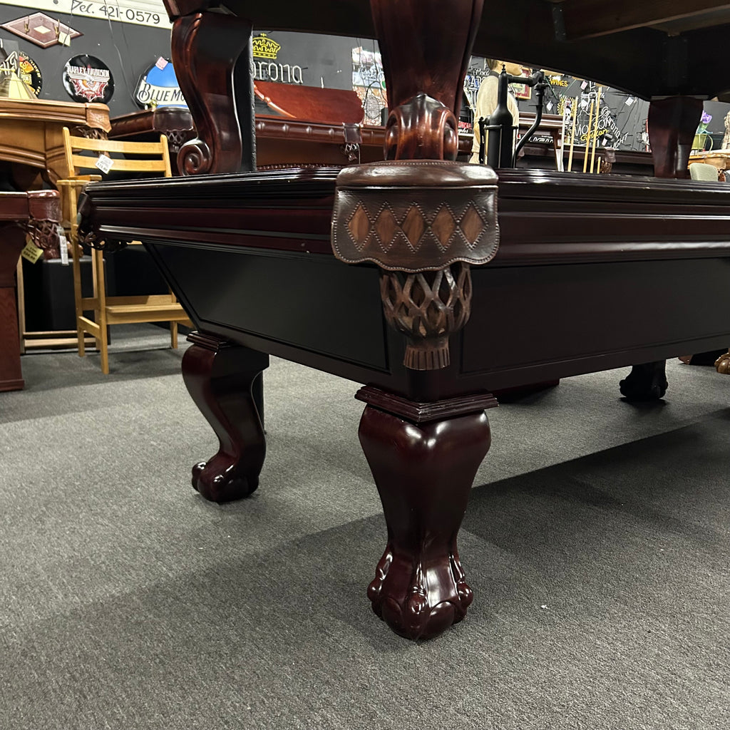 Corner view of mahogany imperial pool table with ball and claw leg and shield pocket