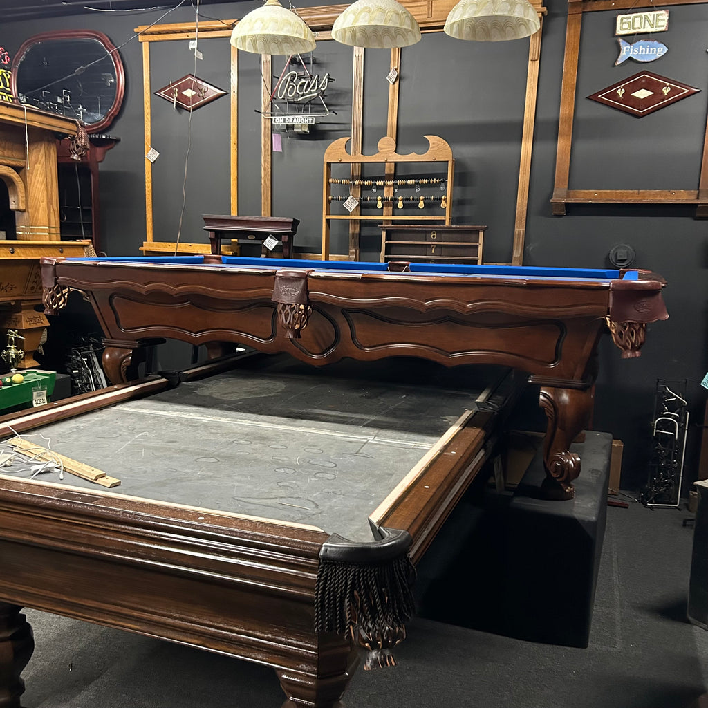 Overall view of olhausen pool table with scalloped rail and arched cabionet