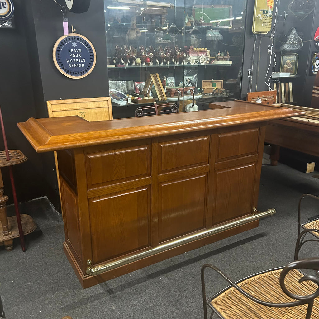 Pecan dry bar with brass footrail and raised front paneling
