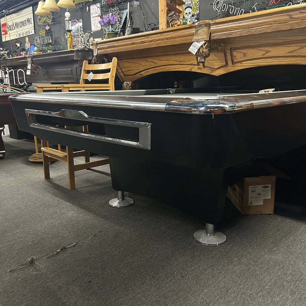 Corner view of pool table with black finish and chrome castings