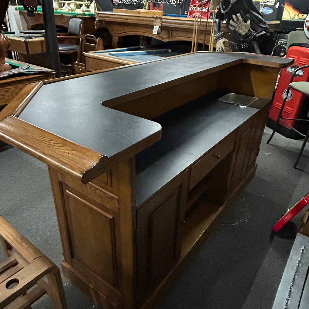 Back view of oak bar with black laminate top