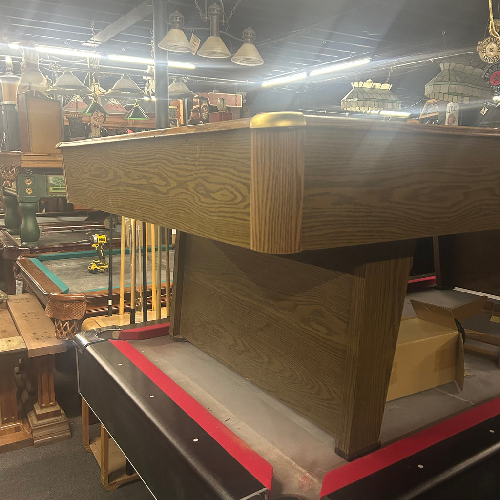 Corner view of pool table with brass corner caps and pedestal leg