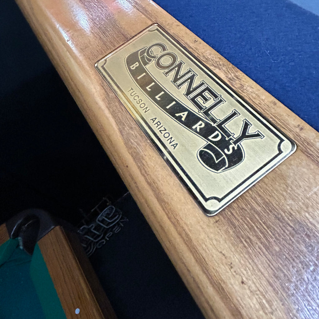 Label connelly billiards on oak rail with blue felt