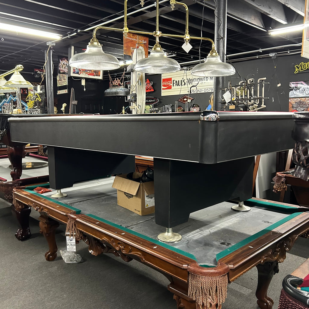 Overall view of black eliminator pool table with pedestal base leg and chrome corner caps