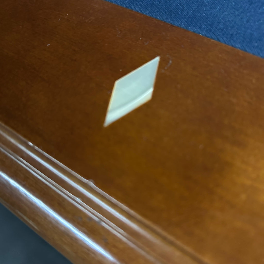 Closeup of wooden pool table rail with diamond rail site