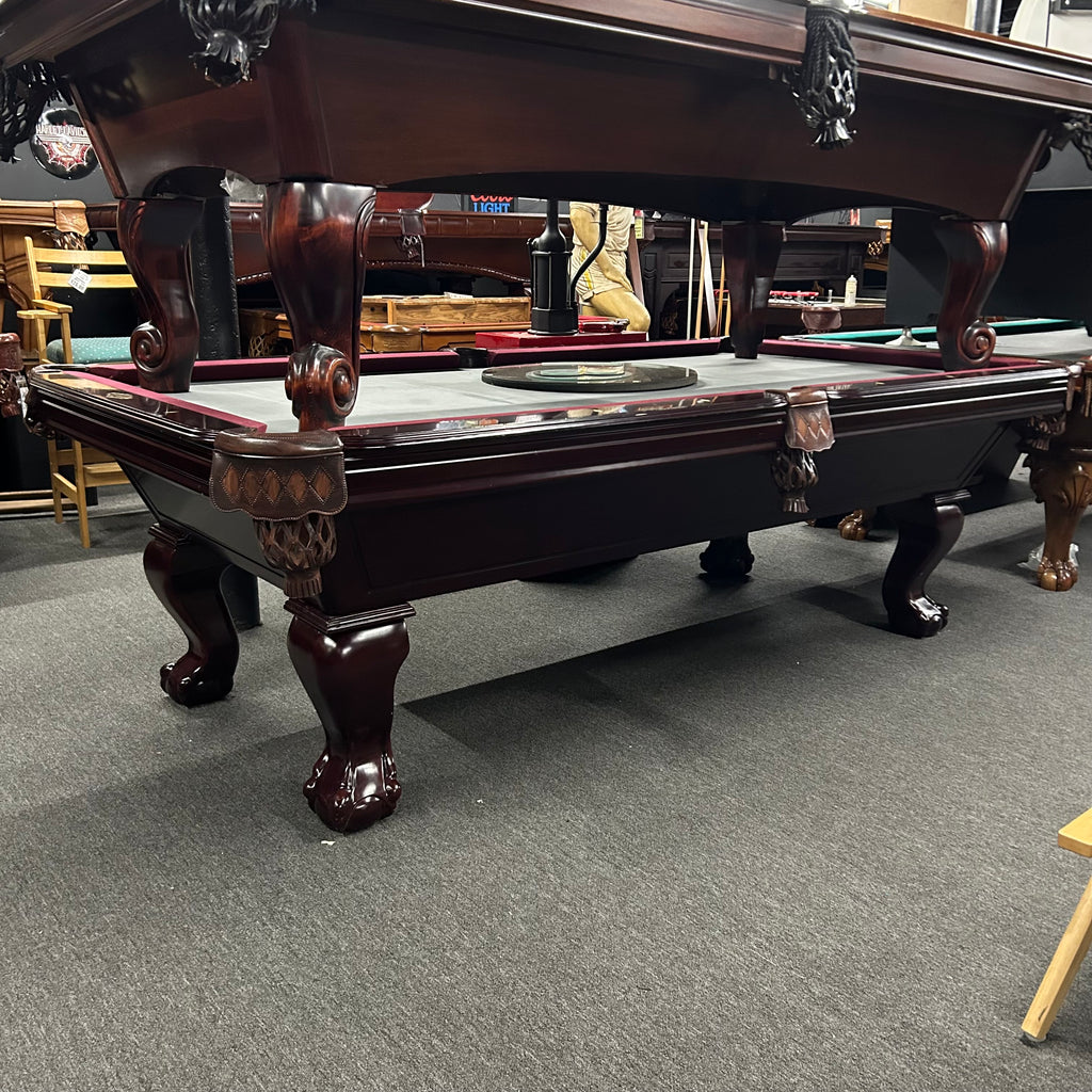 Overall view from left of mahogany imperial pool table with ball and claw leg and shield pocket