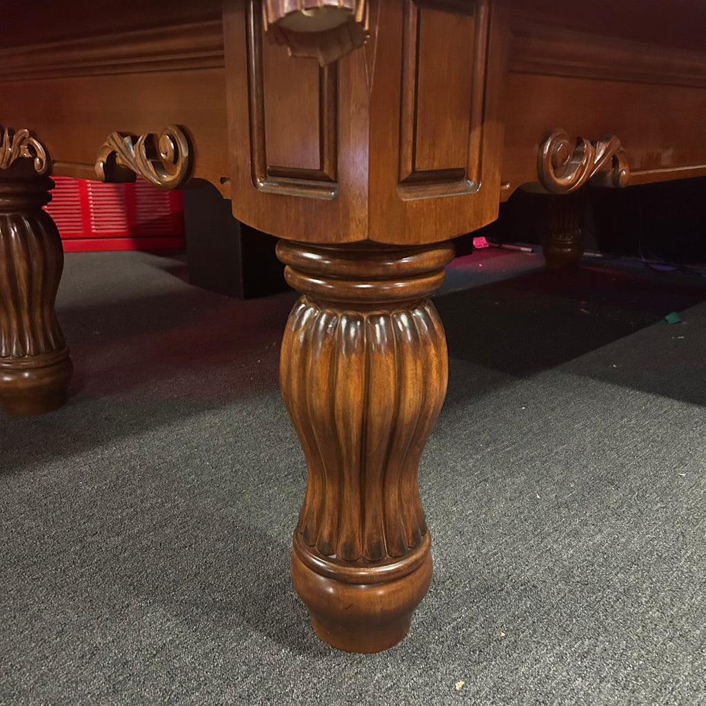 Turned pool table leg on pool table in chestnut finish