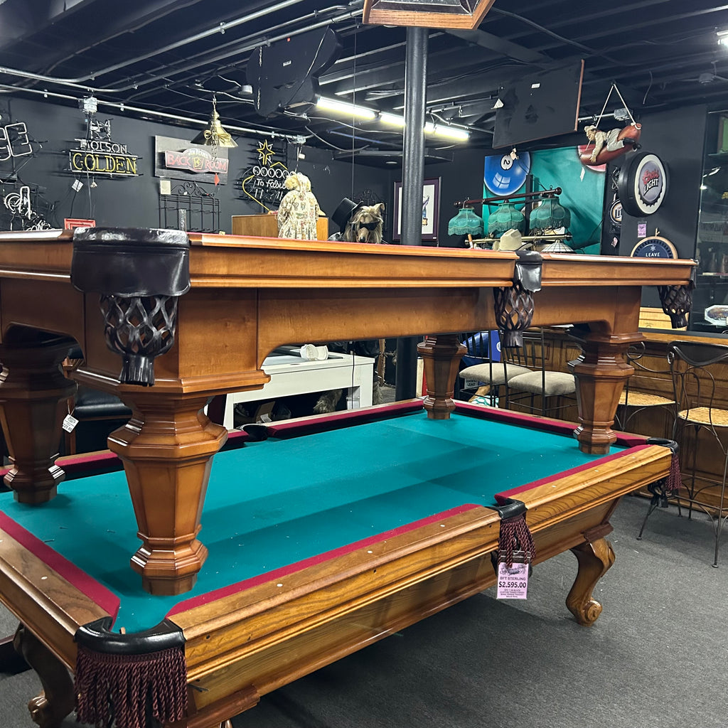 Maple pool table with black shield pockets and round tapered legs