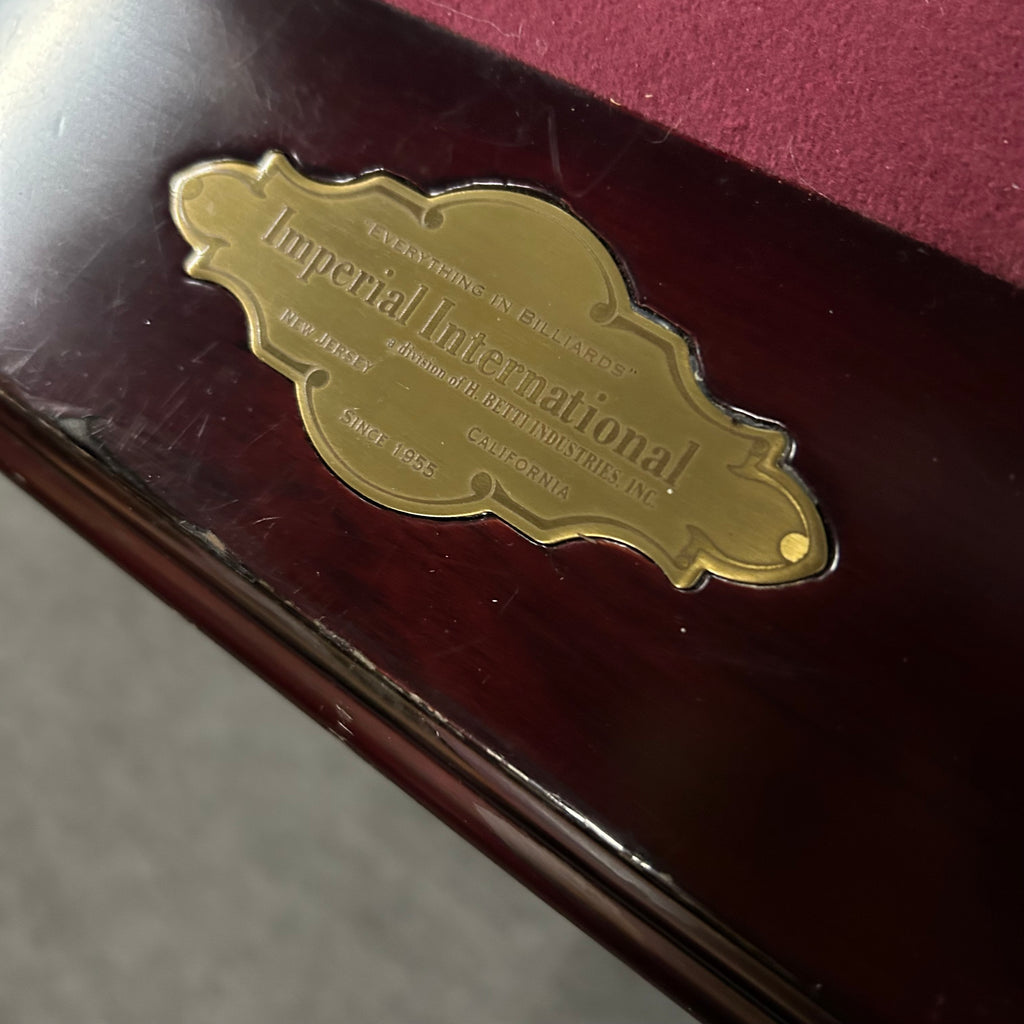 Label of imperial pool table on rail with burgandy cloth