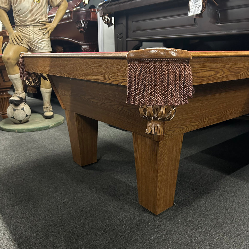 Corner view of olhausen in medium oak finish with tan pockets fringe