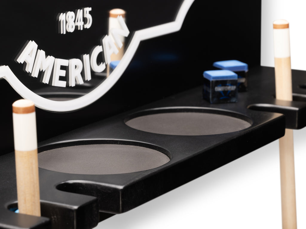 close up of brunswick mirror with chalk and cup holders with cues