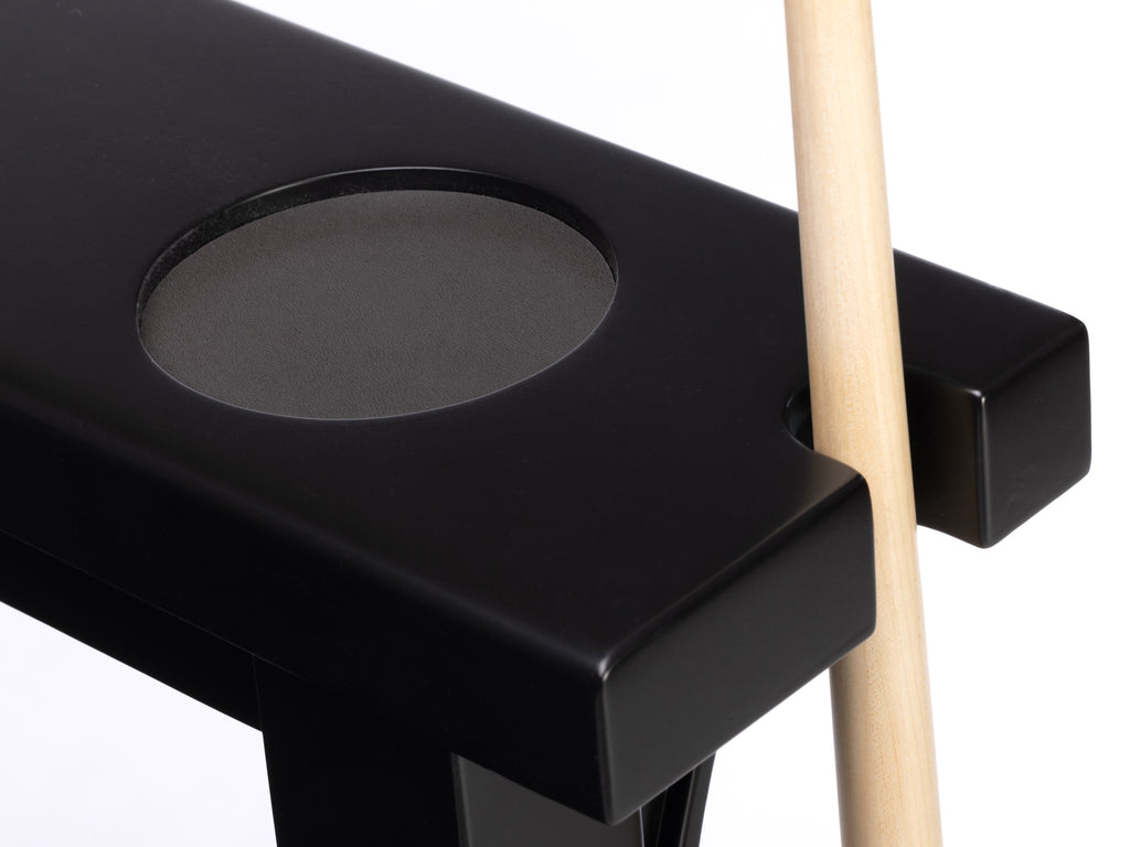 Black cup holder on chair with cue stick in the rivet