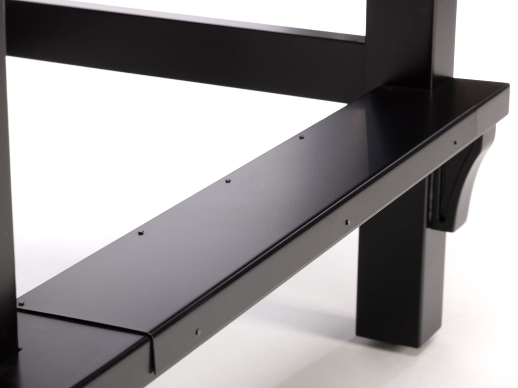 Black metal foot rail on spectator chair